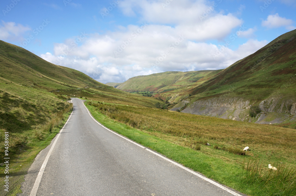 Narrow single lane country road near Cymystwyth in Wales UK.