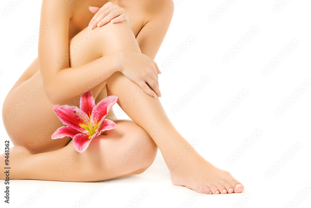 Female legs with pink lily isolated on white background - obrazy, fototapety, plakaty 