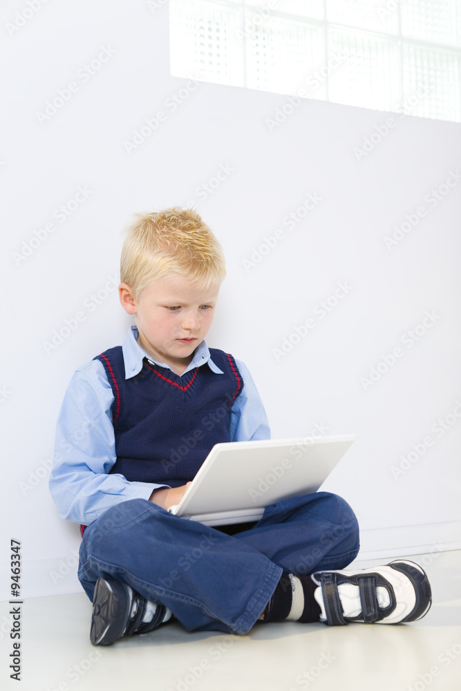 Young schoolboy with laptop Young schoolboy with laptop
