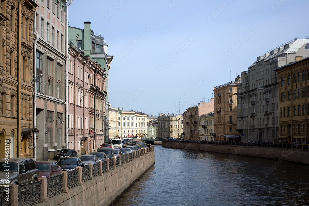 Kind on quay, houses and cars in the center of Petersburg.