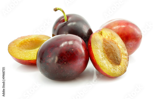 ripe plums fruits with cut isolated on white background