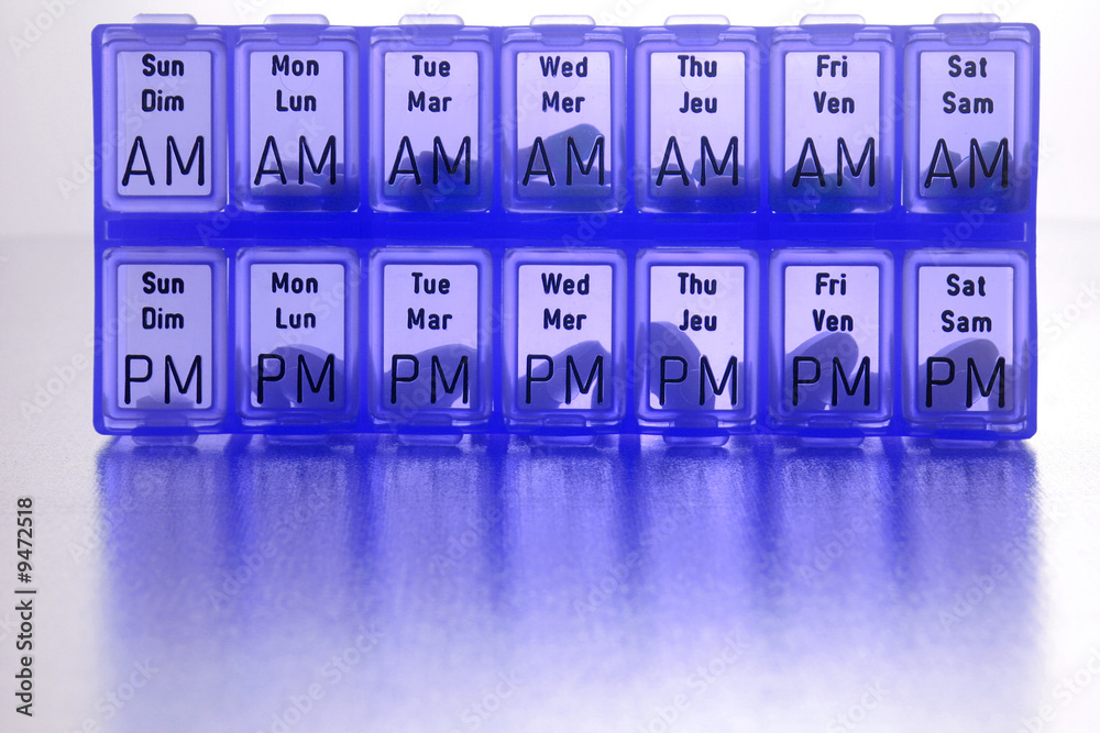 different kinds of pills in slots of daily reminder cannister different kinds of pills in slots of daily reminder cannister