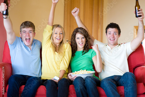 Four young adults having fun at home