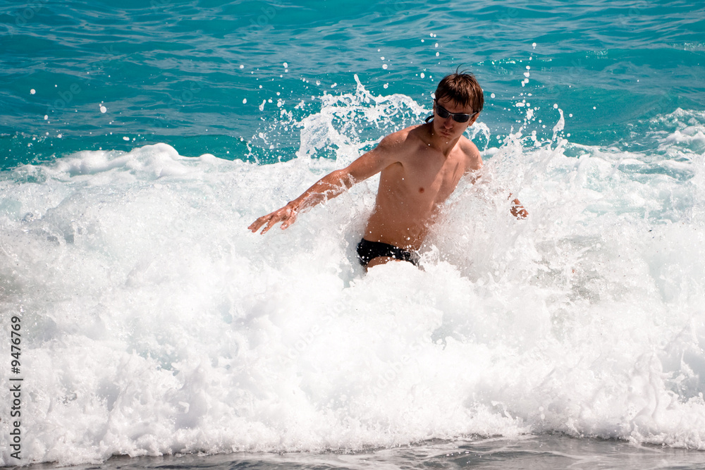 Young man in the ocean waves
