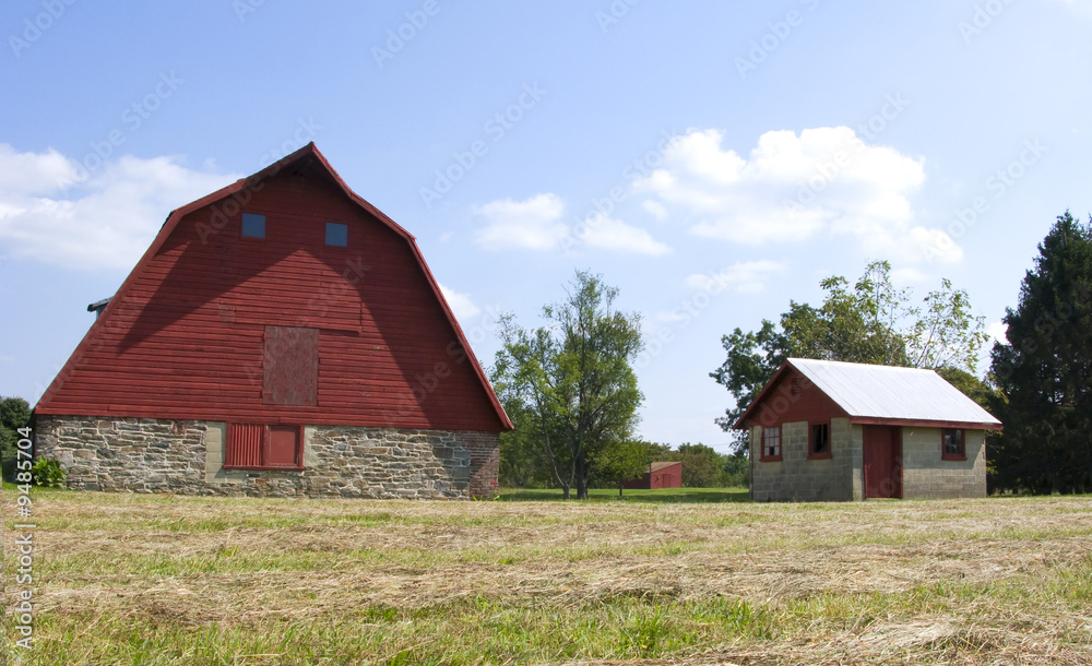 A traditional red barn and small shed A traditional red barn and small shed