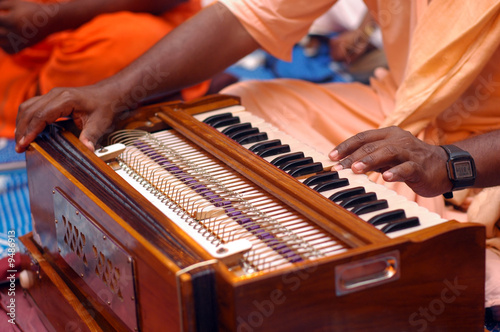 Foto Krishna Devotee Playing Harmonium
