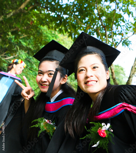 Beautiful Asian university graduates celebrate their success.