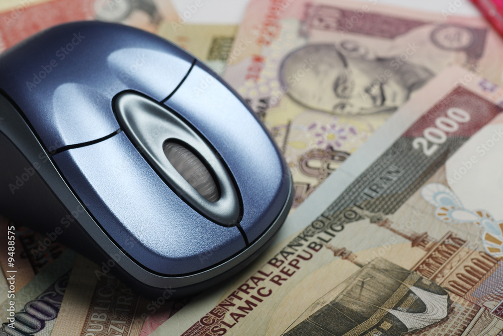 Mouse with indian and iranian currency in background Mouse with indian and iranian currency in background