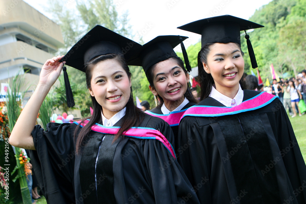 Beautiful Asian university graduates celebrate their success. Beautiful Asian university graduates celebrate their success.
