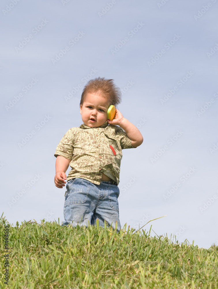 Little boy holding a toy cellphone near his ear Little boy holding a toy cellphone near his ear