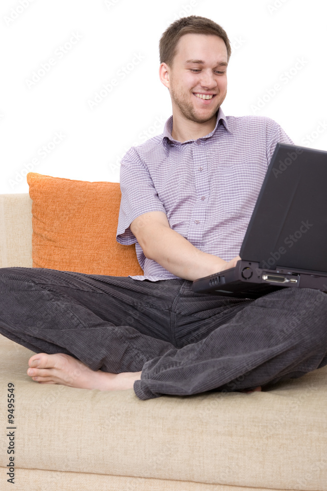 casual man sitting on sofa with laptop