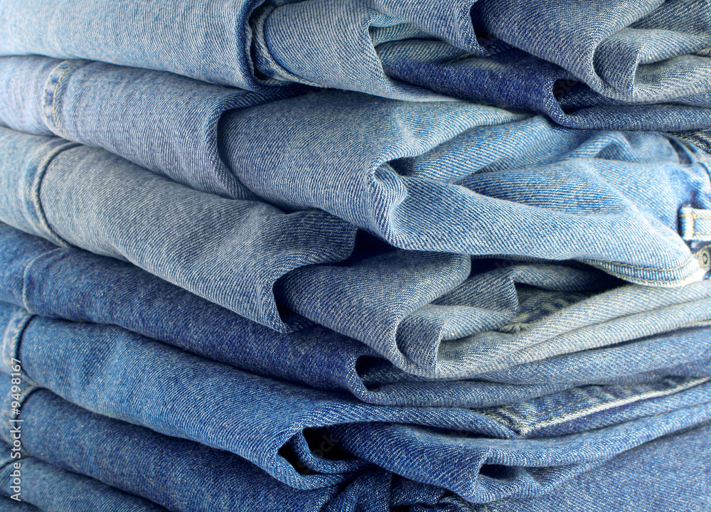 pile of different shades of blue jeans pile of different shades of blue jeans