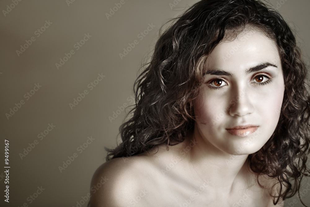 Brunette happy teenage girl with curly hair – sepia finish. Brunette happy teenage girl with curly hair – sepia finish.