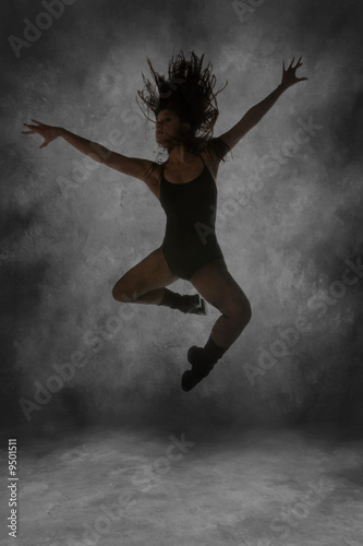 Young Street Dancer Leaping Mid Air With Dramatic Lighting