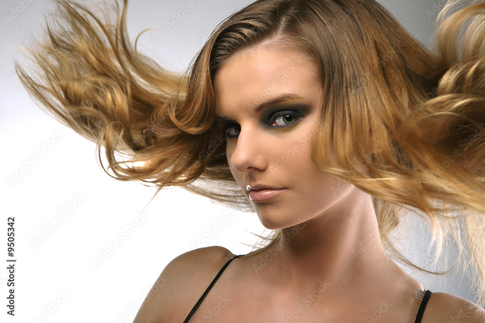 Girl with hair lightly fluttering in the wind. Girl with hair lightly fluttering in the wind.