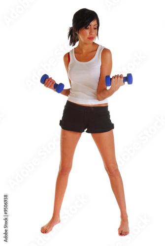 Attractive latino woman working out with two dumbells