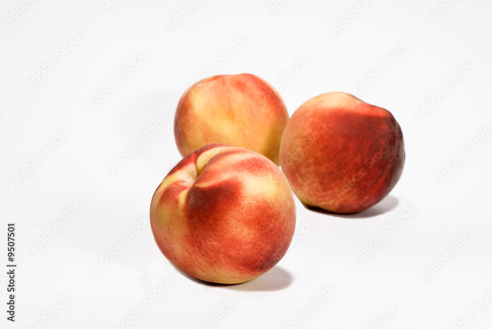 three ripe fresh peaches over white background three ripe fresh peaches over white background