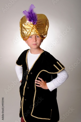 Young boy wearing a Sultan or Shiek's halloween costume.