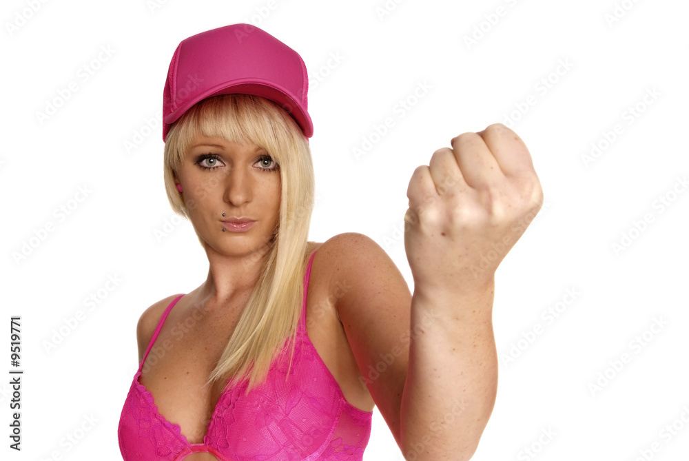 young blonde woman in pink clench fist