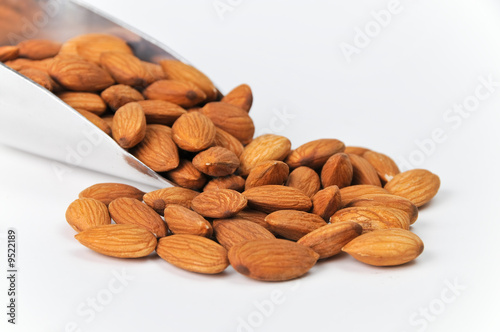 Fresh Raw Almonds in Aluminum Scoop Isolated on White Background