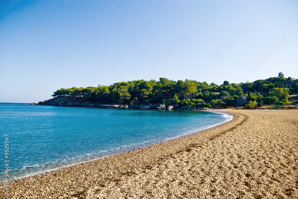 Peaceful beach scene with sea and blue sky