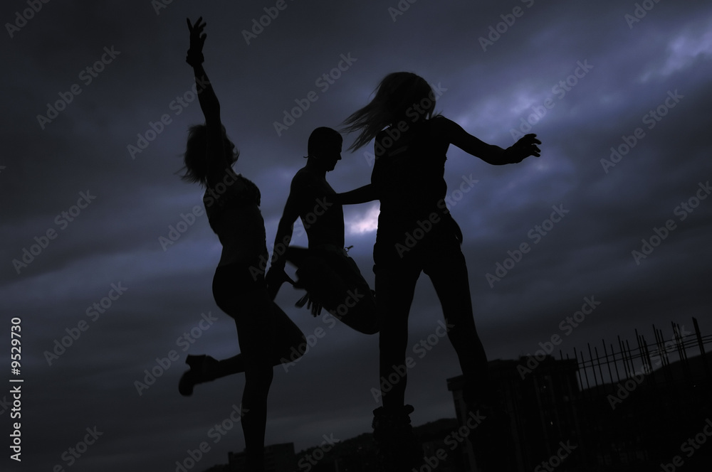 group of people jumping in air in night