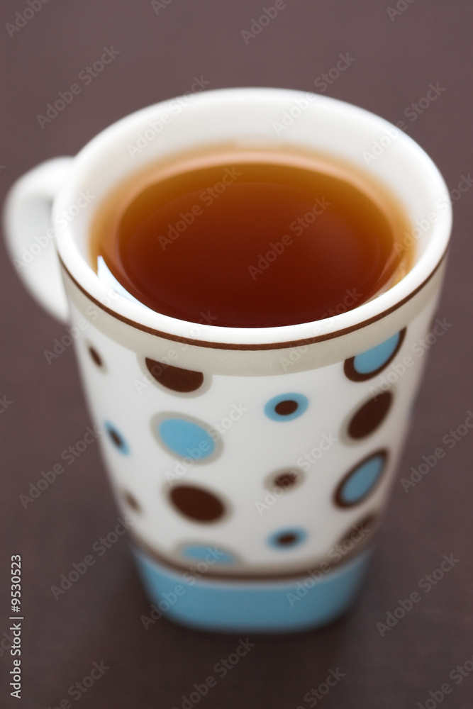A cup of black tea in a small modern mug. A cup of black tea in a small modern mug.