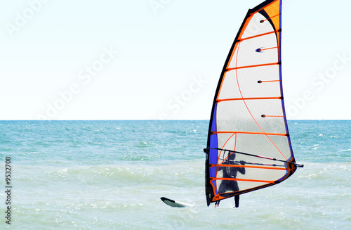 Silhouette of a windsurfer on the sea in the afternoon