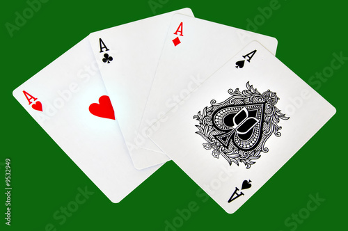 Four aces isolated in a green background with clipping path photo