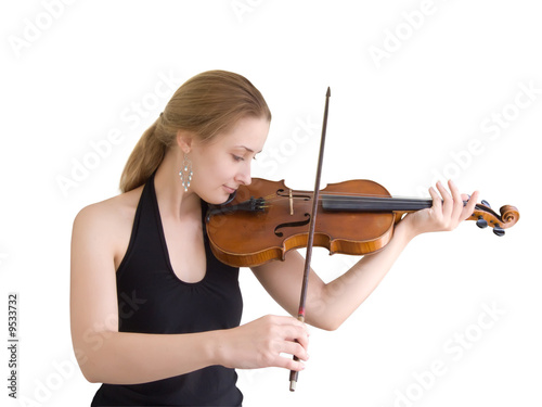 A young girl plays on a violin