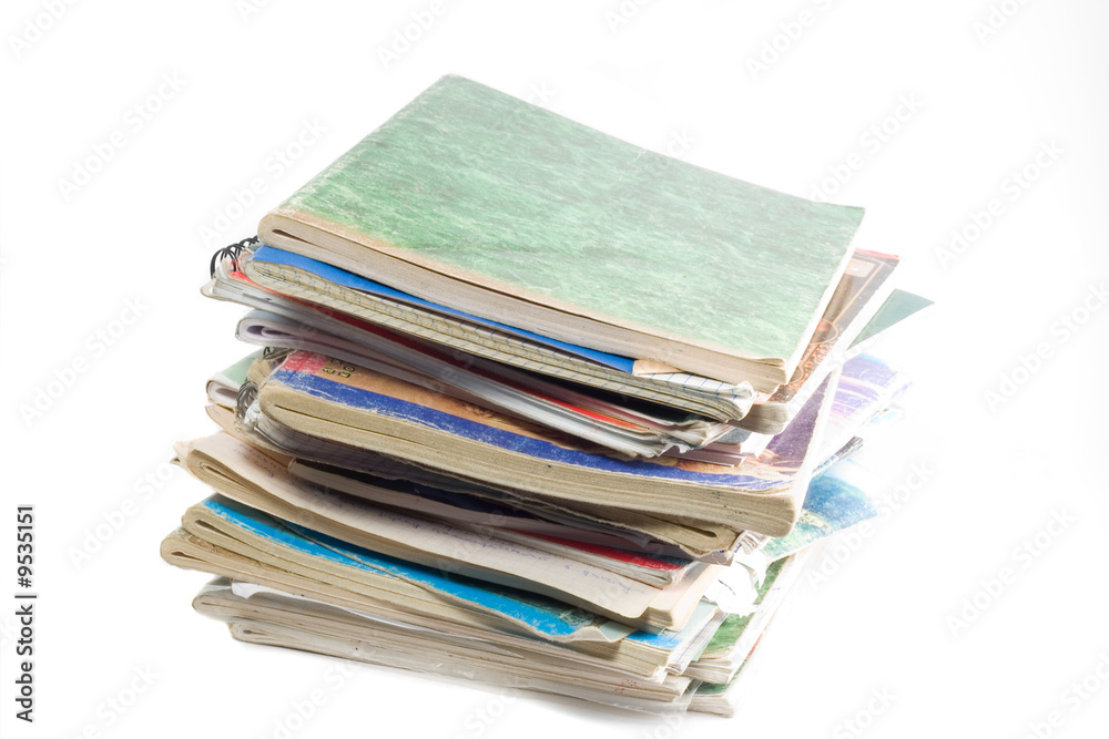 column of old copybooks isolated over white column of old copybooks isolated over white