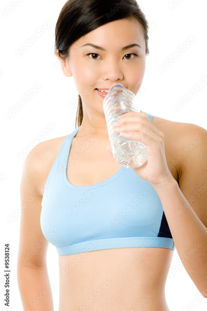 A young attractive Asian woman in sportswear holding a bottle A young attractive Asian woman in sportswear holding a bottle