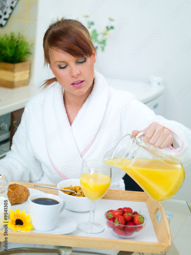 Beautiful woman in kitchen eating tasty breakfast Beautiful woman in kitchen eating tasty breakfast