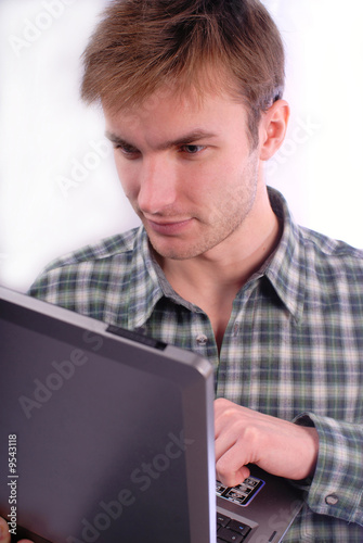 Young  man with concentration works on  computer