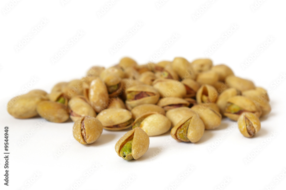 Obraz premium Heap of salty pistachios isolated. Soft focus