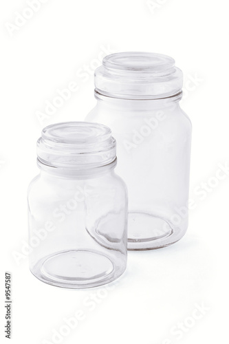 Two empty glass jars side by side on white background