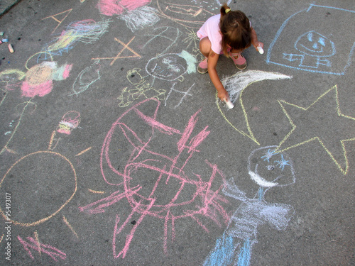 little girl drawing on the street