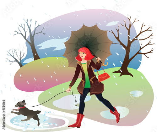 Woman walking a dog in the autumn park