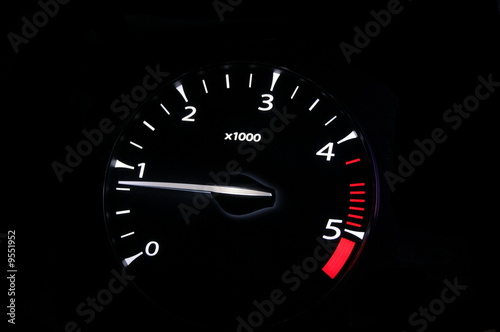 moving revs meter of a sports car on a black background.