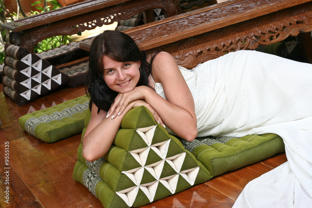 Fototapeta premium Beautiful bride relaxing on a Thai cushion.