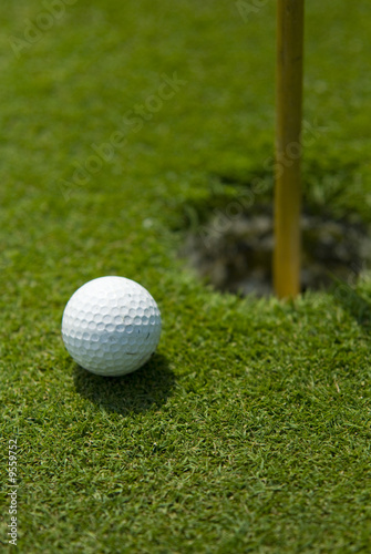 Golf club view of Golf ball in the putting green - sport