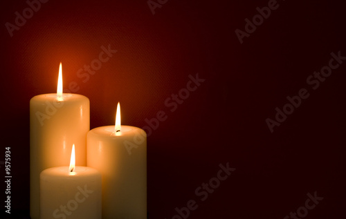 Three candles on a red background