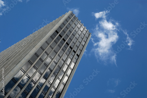 office building with a blue sky and clouds