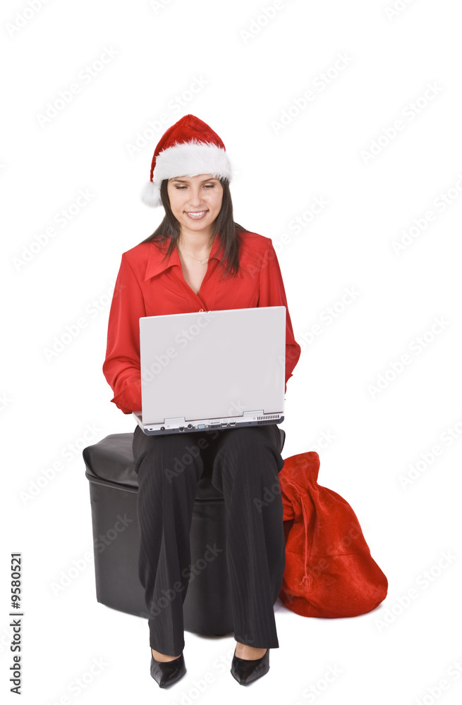 Young woman in red clothes and hat working on a laptop. Young woman in red clothes and hat working on a laptop.