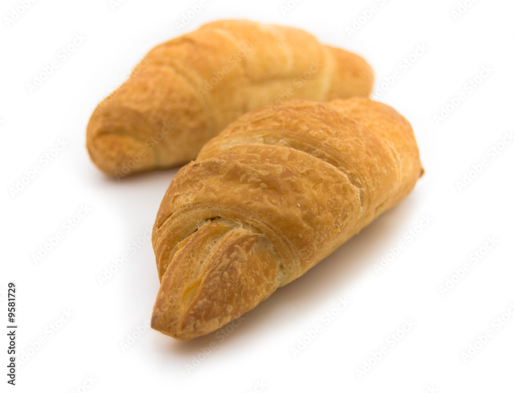 two fresh croissants on white background