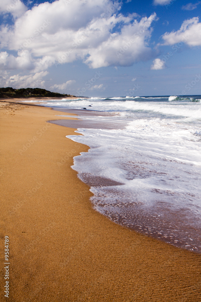 Foaming waves crashing onto the beach