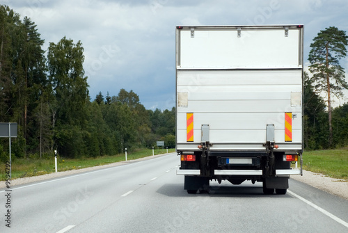 Road - White Cargo Van Transporting Goods