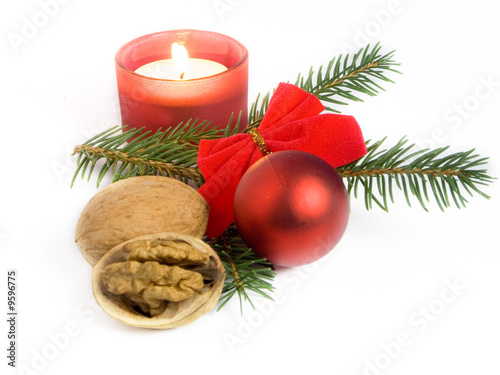 Christmas still life with Christmas ball, candle and walnuts