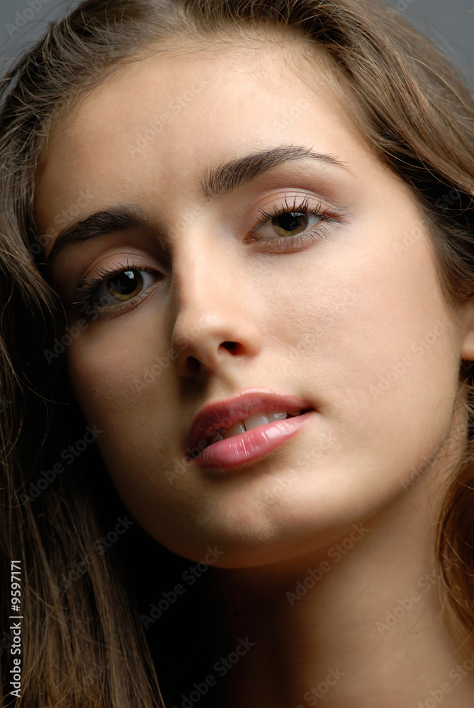 Fototapeta premium portrait of the young girl on dark background in studio