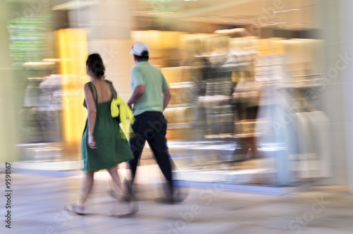 Couple shopping in a mall, panning shot, intentional motion blur photo